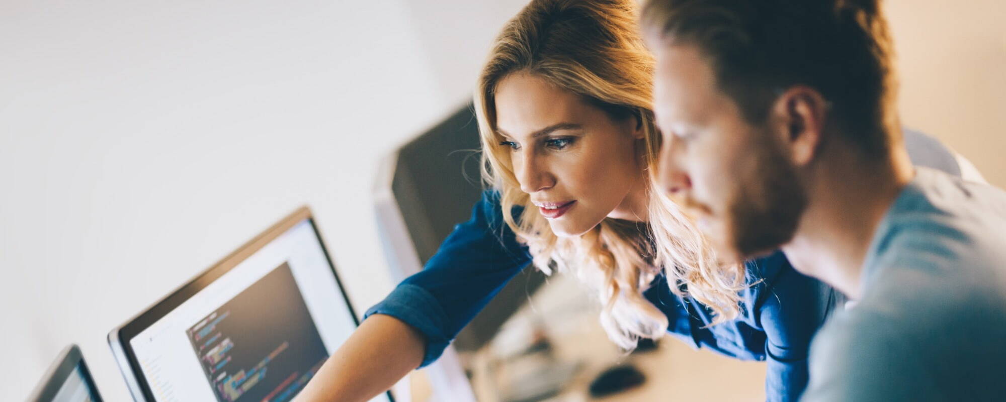 Employees working in the office looking at the computer