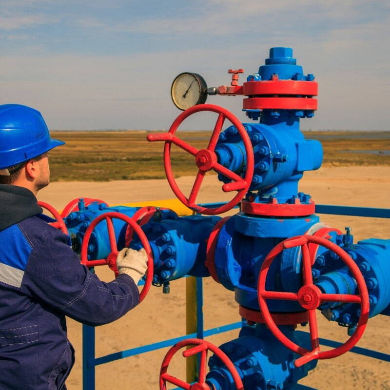 Oil and Gas field worker managing pipelines